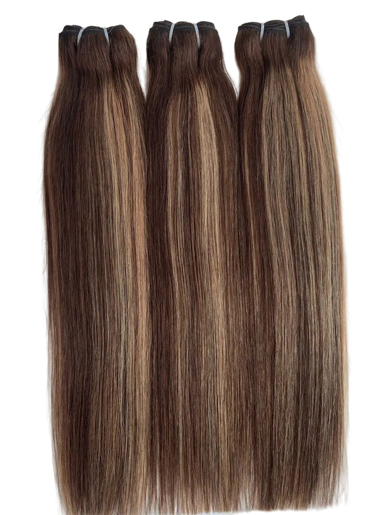 Three bundles of straight hair extensions laid flat on a white background, featuring a dark brown root color with warm caramel and light brown highlights.